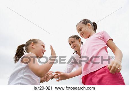 Three girls playing View Large Photo Image Stock Image - Three girls playing. Fotosearch