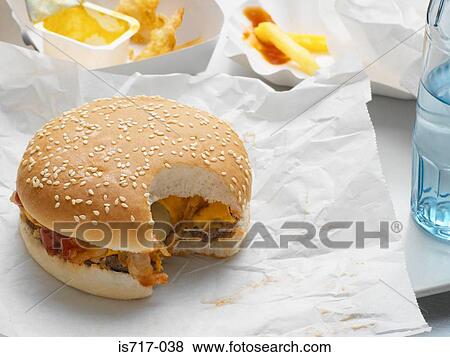 Cheeseburger with missing bite View Large Photo Image Stock Photo - Cheeseburger with missing bite. Fotosearch