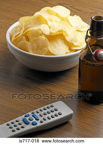 Crisps with beer and remote control View Large Photo Image Stock Photo - Crisps with beer and remote control. Fotosearch