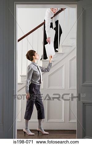 Woman passing paper to man View Large Photo Image Stock Image - Woman passing paper to man. Fotosearch