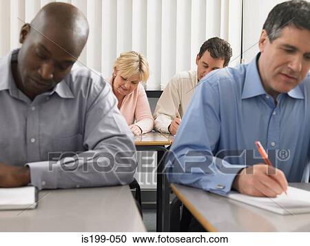 Stock Image - Mature students in a lesson. Fotosearch