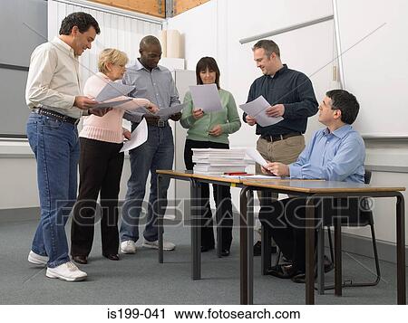 Mature students looking at papers View Large Photo Image Stock Image - Mature students looking at papers. Fotosearch