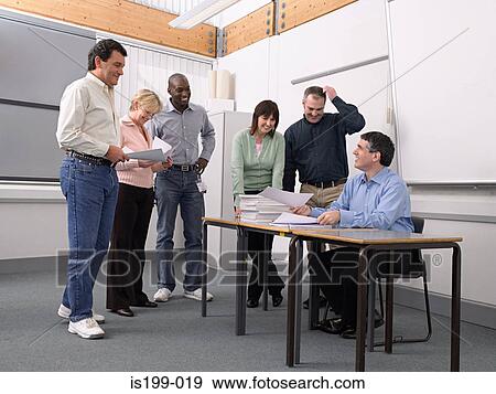 Mature students looking at papers View Large Photo Image Stock Photo - Mature students looking at papers. Fotosearch