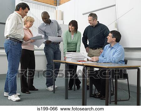 Stock Photograph - Mature students looking at papers. Fotosearch