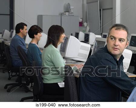 Stock Image - Mature students using computer. Fotosearch