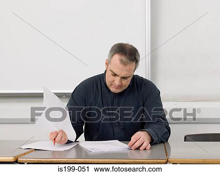 Teacher marking paperwork View Large Photo Image Stock Image - Teacher marking paperwork. Fotosearch