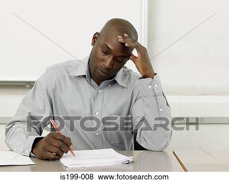 Stock Photo - Teacher marking paperwork. Fotosearch