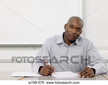Stock Photo - Teacher marking paperwork. Fotosearch