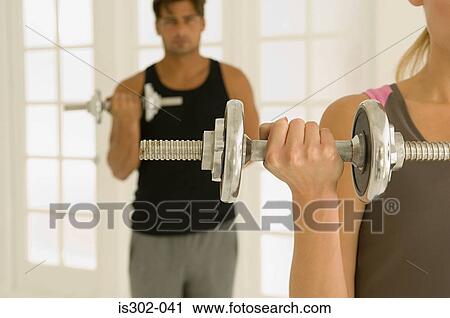 Couple weight training View Large Photo Image Stock Image - Couple weight training. Fotosearch