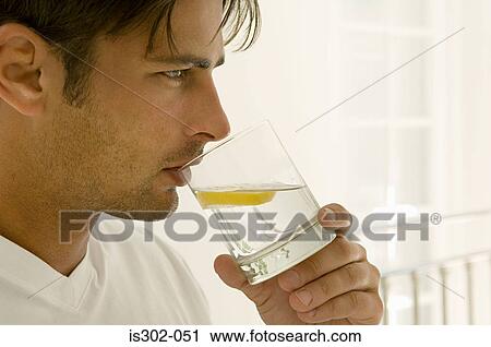 Man drinking water with lemon View Large Photo Image Stock Image - Man drinking water with lemon. Fotosearch