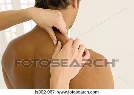 Man having his shoulders massaged View Large Photo Image Stock Photo - Man having his shoulders massaged. Fotosearch