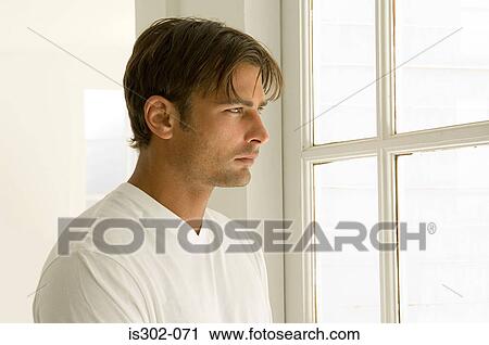 Man looking out of window View Large Photo Image Stock Image - Man looking out of window. Fotosearch