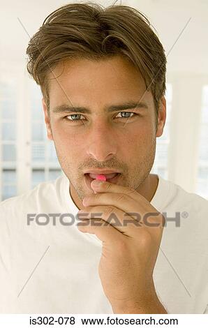Stock Photo - Man taking a tablet. Fotosearch