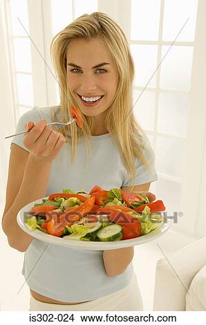 Woman eating salad View Large Photo Image Picture - Woman eating salad. Fotosearch