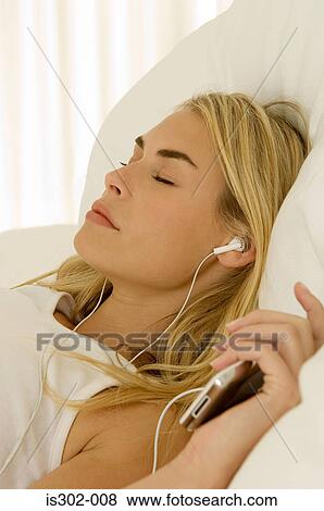 Woman listening to MP3 player View Large Photo Image Stock Photo - Woman listening to MP3 player. Fotosearch
