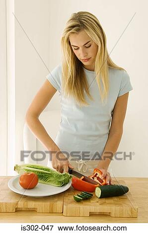 Stock Photo - Woman preparing salad. Fotosearch