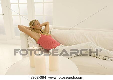 Woman relaxing on sofa View Large Photo Image Picture - Woman relaxing on sofa. Fotosearch
