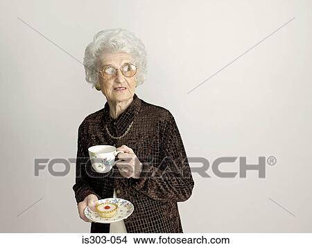 Senior woman with tea and cake View Large Photo Image Picture - Senior woman with tea and cake. Fotosearch
