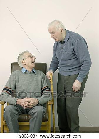 Two senior men chatting View Large Photo Image Stock Photo - Two senior men chatting. Fotosearch