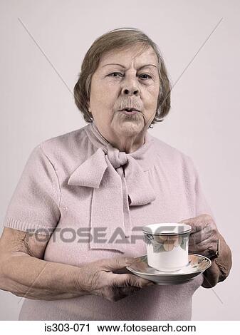 Woman with a teacup and saucer View Large Photo Image Stock Image - Woman with a teacup and saucer. Fotosearch