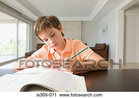 Stock Image - Boy doing his homework. Fotosearch