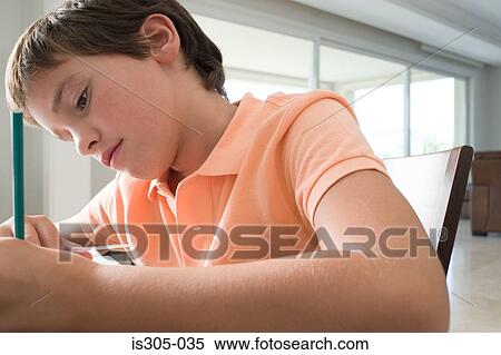 Stock Photography - Boy doing homework. Fotosearch