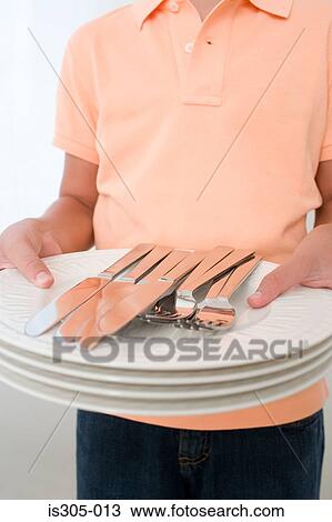 Boy holding plates and cutlery View Large Photo Image Stock Image - Boy holding plates and cutlery. Fotosearch