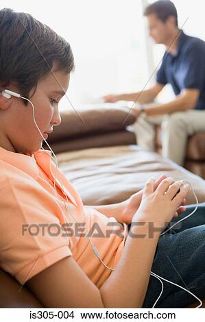 Boy listening to MP3 player View Large Photo Image Picture - Boy listening to MP3 player. Fotosearch