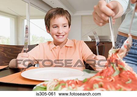 Stock Image - Boy waiting for spaghetti. Fotosearch