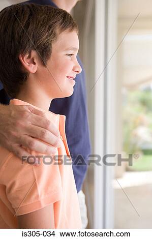 Boy with father's hand on his shoulder View Large Photo Image Picture - Boy with father's hand on his shoulder. Fotosearch