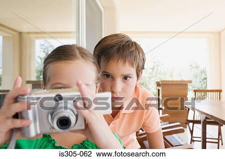 Brother and sister with digital camera View Large Photo Image Stock Image - Brother and sister with digital camera. Fotosearch