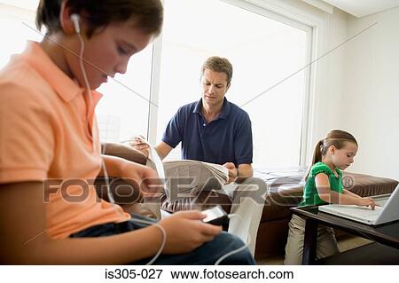 Family doing separate activities View Large Photo Image Stock Photo - Family doing separate activities. Fotosearch