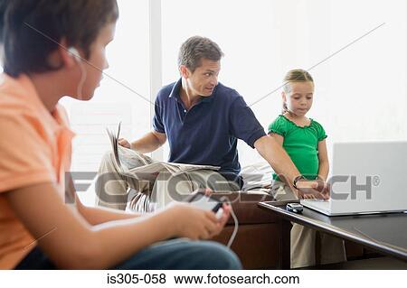 Father helping daughter use laptop View Large Photo Image Stock Photo - Father helping daughter use laptop. Fotosearch
