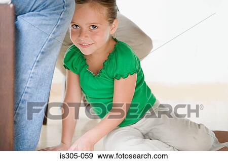 Girl sitting by adult legs View Large Photo Image Stock Photo - Girl sitting by adult legs. Fotosearch