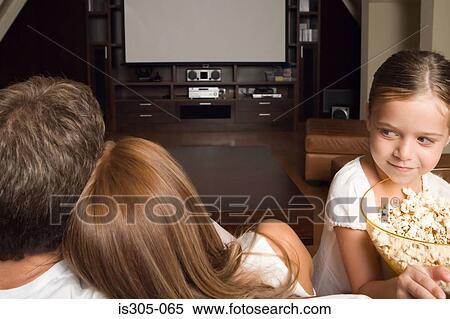 Girl with popcorn and family View Large Photo Image Stock Photography - Girl with popcorn and family. Fotosearch