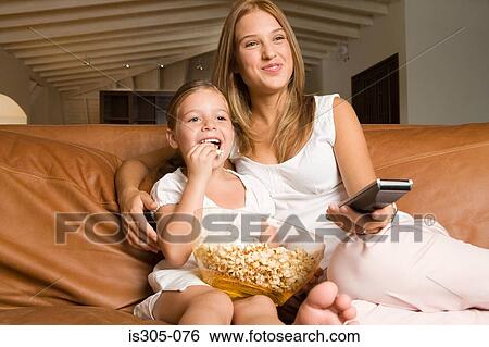Sisters watching a movie View Large Photo Image Stock Photograph - Sisters watching a movie. Fotosearch