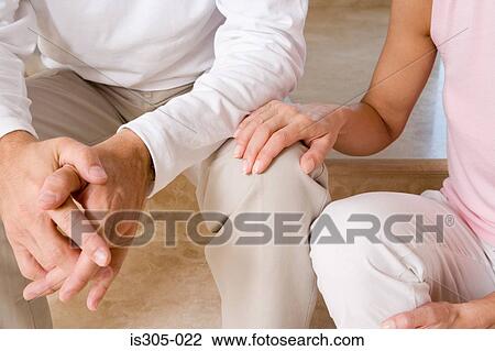 Woman with hand on man's knee View Large Photo Image Stock Image - Woman with hand on man's knee. Fotosearch