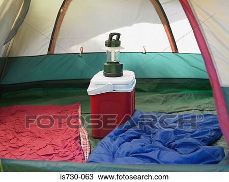Stock Image - Coolbox in a tent. Fotosearch