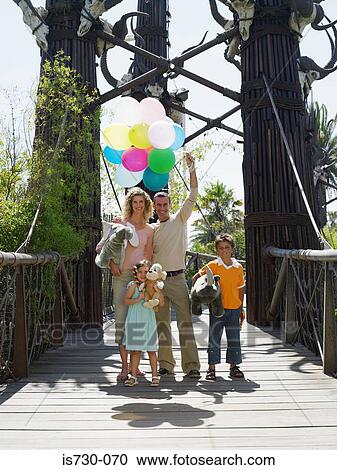 Stock Image - Family at amusement park. Fotosearch