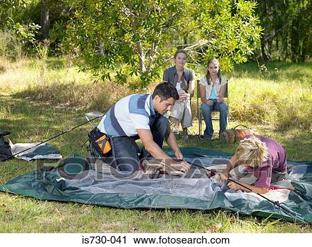 Family putting up tent View Large Photo Image Stock Image - Family putting up tent. Fotosearch