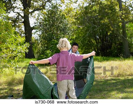 Father and son putting up tent View Large Photo Image Stock Photo - Father and son putting up tent. Fotosearch