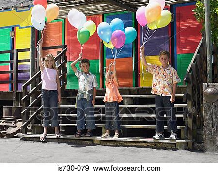 Kids with balloons View Large Photo Image Stock Photo - Kids with balloons. Fotosearch