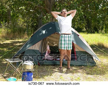 Man stretching outside tent View Large Photo Image Stock Photo - Man stretching outside tent. Fotosearch