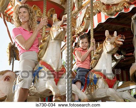 Picture - Mother and daughter on carousel. Fotosearch