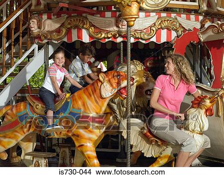Picture - Mother and kids on a carousel. Fotosearch