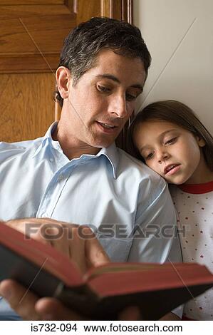 Father reading bible to daughter View Large Photo Image Picture - Father reading bible to daughter. Fotosearch