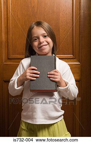 Girl holding a bible View Large Photo Image Picture - Girl holding a bible. Fotosearch