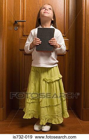 Stock Photo - Girl holding the bible. Fotosearch