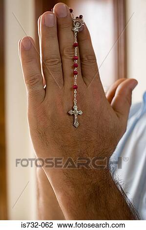 Man holding a rosary View Large Photo Image Stock Image - Man holding a rosary. Fotosearch