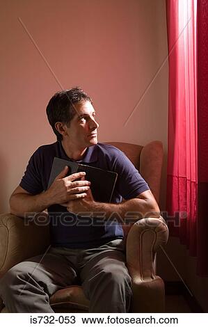Stock Image - Man holding the bible. Fotosearch